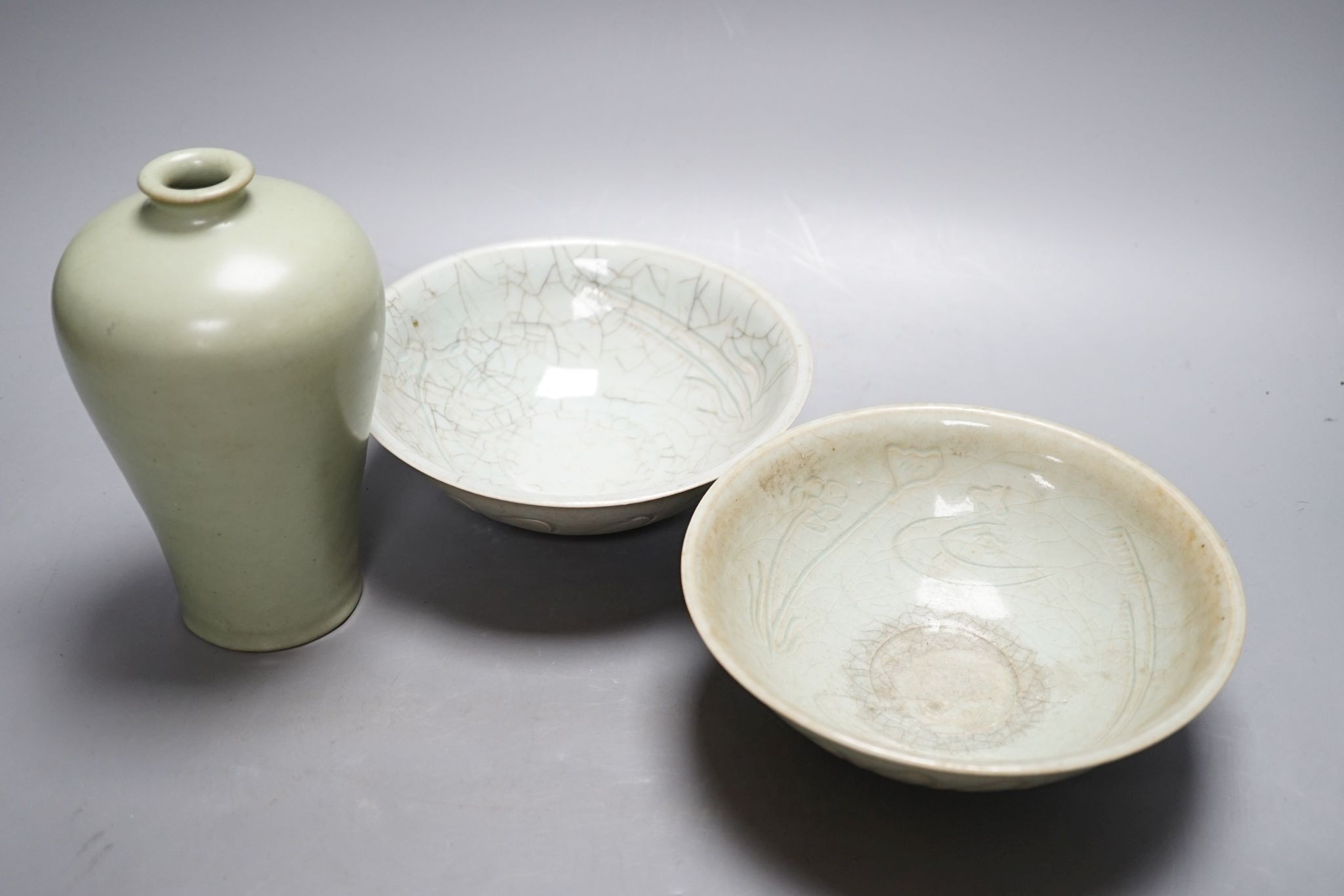 Two Chinese carved celadon dishes, 18cm. diam., and a celadon vase